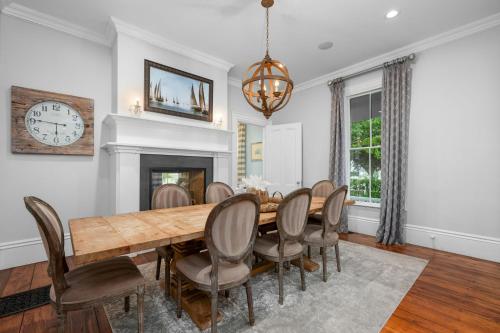 a dining room with a table and chairs and a fireplace at 525 Route 28 Harwich Port Cape Cod - - The Mooring in Harwich Port