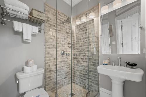 a bathroom with a shower and a toilet and a sink at 525 Route 28 Harwich Port Cape Cod - - The Mooring in Harwich Port