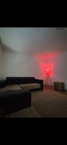 a living room with a couch and a red light at Avalon Mali Stapar 