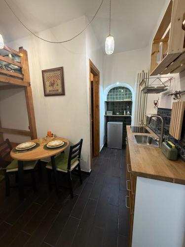 a kitchen with a table and a kitchen with a sink at Casa Carmela Cerasuolo Filignano in Filignano