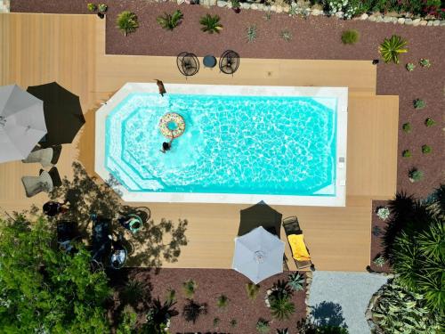 an overhead view of a swimming pool with a person in a life preserverministic at Villa Polyxeni Lavender 150m from the sea in Politiká