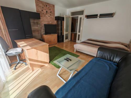 a living room with a couch and a table at Wesselényi Apartment in Kecskemét