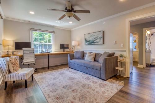 a living room with a couch and a desk at Modern 2 Bedroom Farmhouse Cottage with Hot Tub in Snohomish in Snohomish
