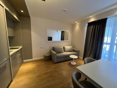 a living room with a couch and a table at alliance pearl Batumi in Batumi