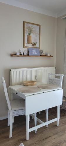a white table and chairs in a room at Villa Rosa in Obernzell