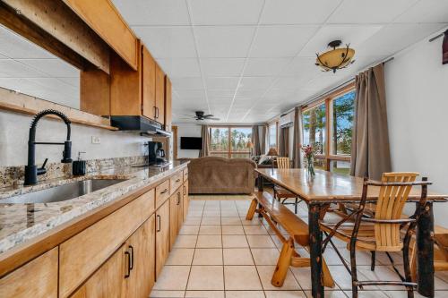 a kitchen with a sink and a table and a couch at Scenic Spider Lake Beach Resort Pontoon Rentals in Traverse City