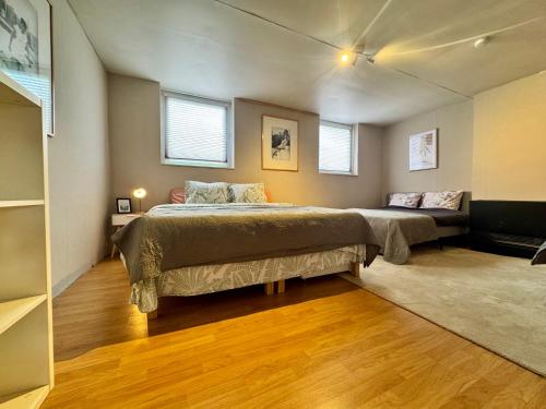 a bedroom with two beds and two windows at Royal Casino Namur Balcony in Namur