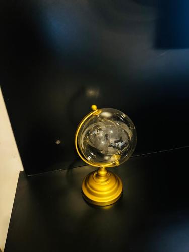 a glass bowl sitting on a black table at The Fig Studio Apartment-A203 in Gaborone