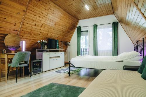 a bedroom with two beds and a desk at Zöld Éden Kabin in Makó