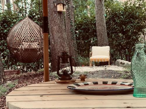 a wooden table with a plate on top of it at Five Trees Forest Home in Lanaken