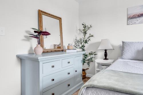 a bedroom with a dresser with a mirror on it at Great Hammock Getaway in Old Saybrook