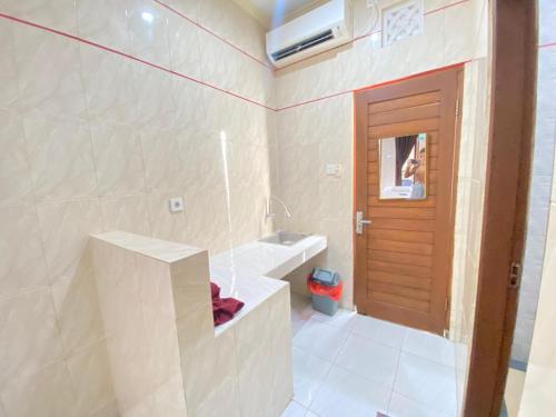 a bathroom with a sink and a bath tub at SG Hotel - 2 Minutes to the Beach By Micky Studio 2 in Legian