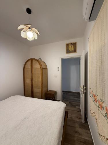 a bedroom with a bed and a ceiling fan at Matilda's house in Majdal Shams