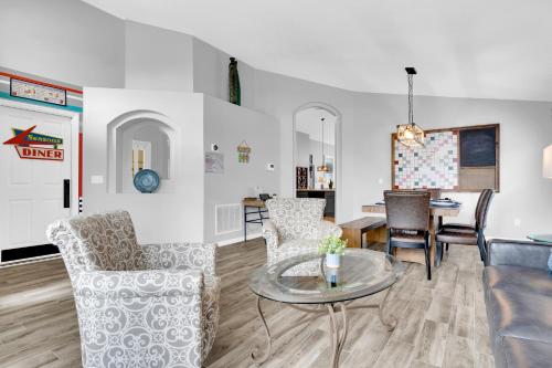 a living room with a table and chairs at South Facing Pool with Spa and a Game Room in Prime Location Near Disney in Kissimmee