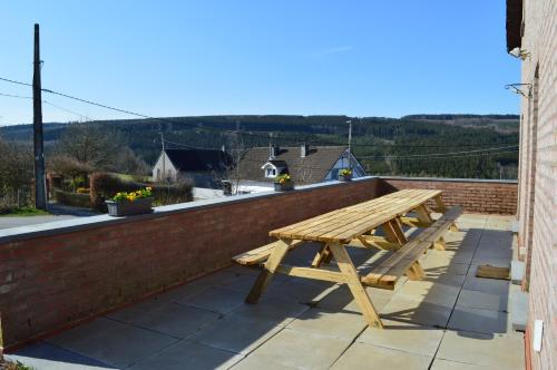 a wooden picnic table on the roof of a house at Grand gîte calme à proximité du circuit de Spa-Francorchamps - Gîte la Bruyère in Stavelot
