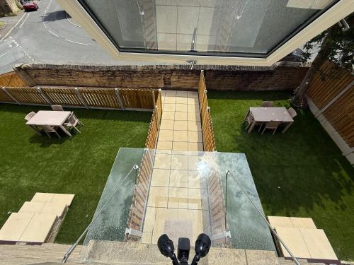 an aerial view of a patio with tables and grass at Luxury Sovereign House in Brighouse