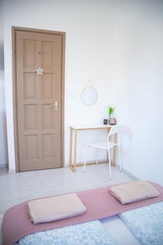 a room with a table and a pink rug and a door at R.Gold Apartman in Makó