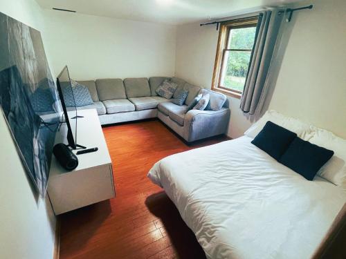 a living room with a bed and a couch at Cabernet Sauvignon Escape in Calgary
