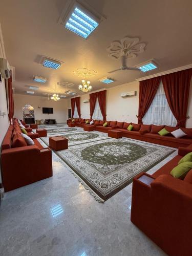 a large living room with couches and a rug at شاليه صحلنوت sahalnoot chalet in Salalah