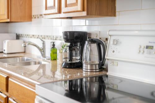 a kitchen counter with a coffee maker and a sink at Elegant 4 Bedroom residence in downtown MTL in Montréal
