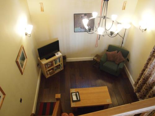 an overhead view of a living room with a television at The Stables at Owlett Hall in Crowle