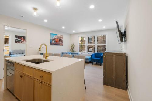 a kitchen with a sink and a living room at 1 Bedroom with Rooftop and Wrigley Views in Chicago