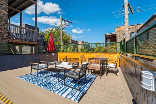 a patio with tables and chairs on a deck at 1 Bedroom with Rooftop and Wrigley Views in Chicago