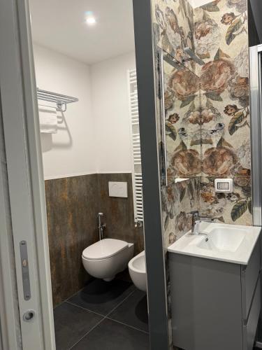 a bathroom with a toilet and a sink at ANGELICA Luxury in Bologna