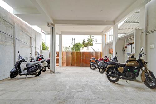a row of motorcycles parked inside of a building at Super Hotel O Jaganath Nagar Near Hopes College in Coimbatore