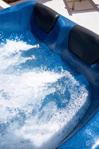 a blue bowl filled with water on a table at Majestic View Villa - Outdoor Jacuzzi in Arkasa