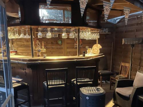 a bar in a restaurant with chairs and glasses at 5 star holiday home in Gräddö in Gräddö