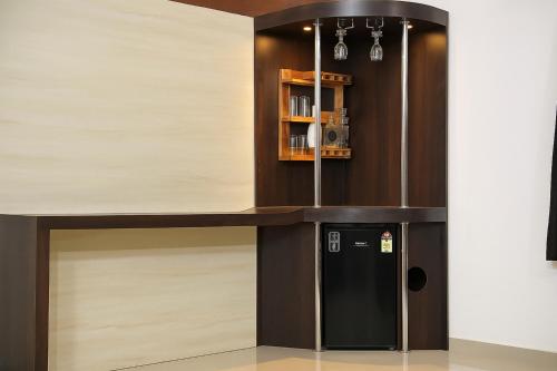 a kitchen with a black refrigerator and a counter at XZ Apartment and Villa with kitchen GOA in Nagoa-Bardez