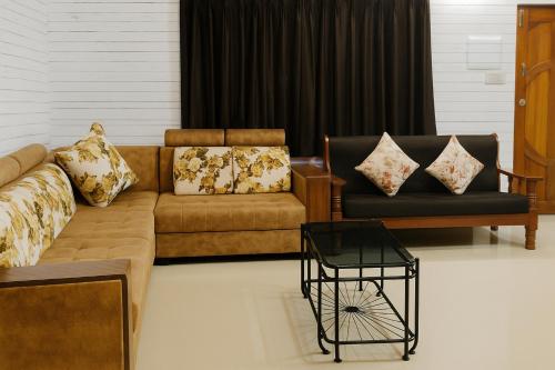 a living room with a couch and two chairs at XZ Apartment and Villa with kitchen GOA in Nagoa-Bardez