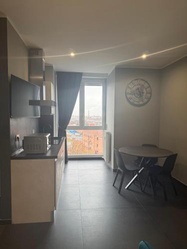 a kitchen with a table and a table and a window at ANGELICA Luxury in Bologna
