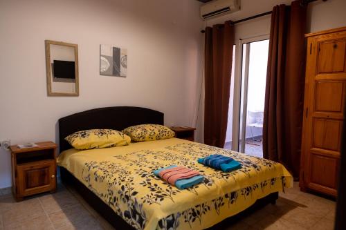 a bedroom with a bed with two towels on it at Villa Serenita in Ulcinj