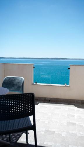 a table and two chairs and a view of the ocean at Pension Augustino in Ražanac