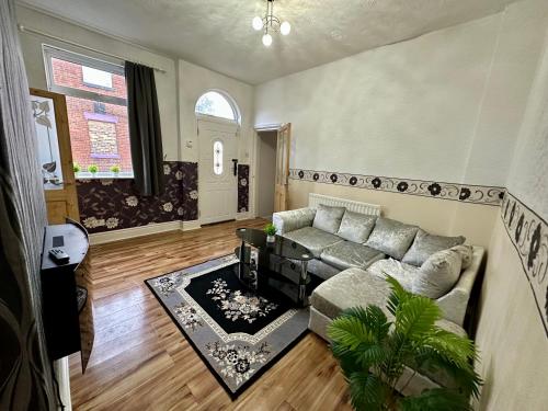 a living room with a couch and a table at Cozy Corner Stoke in Stoke on Trent