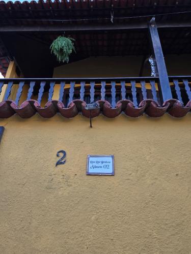 a sign on the side of a building with a roof at Pousada Casa de Buzios in Búzios