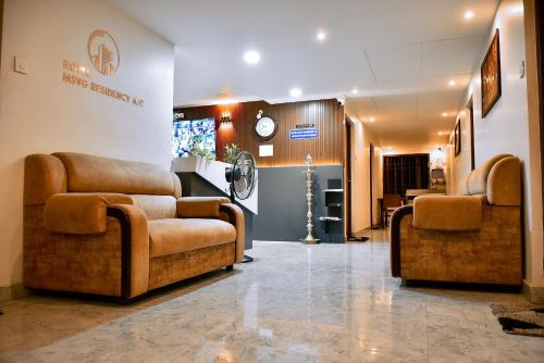 a lobby with two couches and a waiting room at MSVG Residency in Tirunelveli