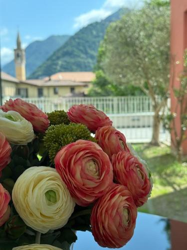 a bouquet of red and white flowers in a vase at Borgo Vico Luxury Suites in Como