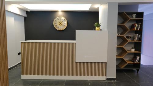 a reception desk with a clock on a wall at Likya 202 in Demre