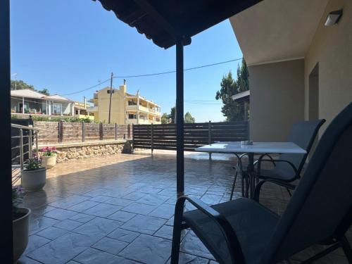 a table and chairs and an umbrella on a patio at Joanna's apartments in Virós