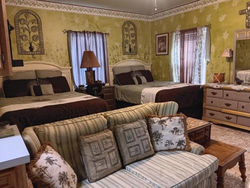 a living room with two beds and a couch at Klauzz in Bay City