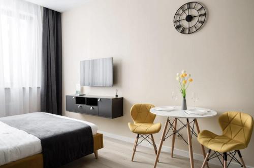 a bedroom with a bed and a table and two chairs at The Stay Hub in Kyiv