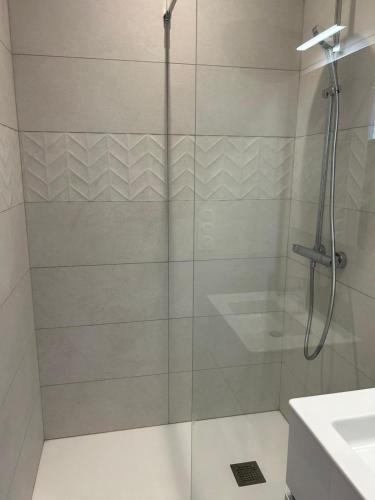 a shower with a glass door in a bathroom at Studio indépendant climatisé à Lyon 8 in Lyon