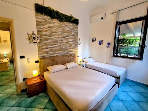 a bedroom with two beds and a brick wall at Villetta Marina in Roseto degli Abruzzi