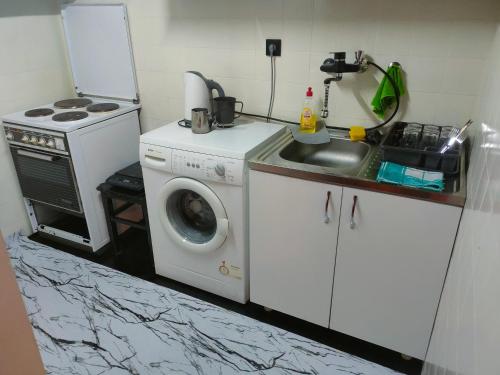 a kitchen with a washing machine and a sink at Industrija in Belgrade