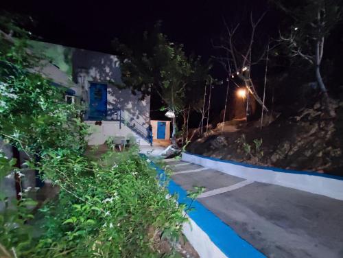a street at night with a blue and white at Villa Kotetsi - Rooms To Let - Volissos - Chios in Volissos