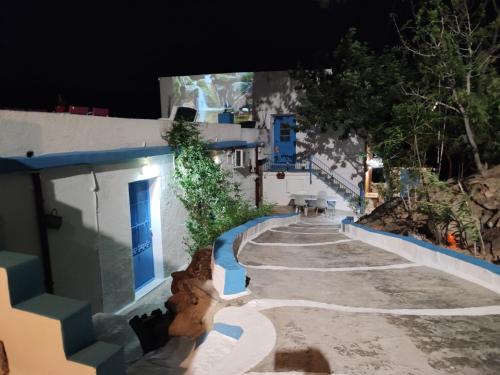 a city street at night with blue and white buildings at Villa Kotetsi - Rooms To Let - Volissos - Chios in Volissos