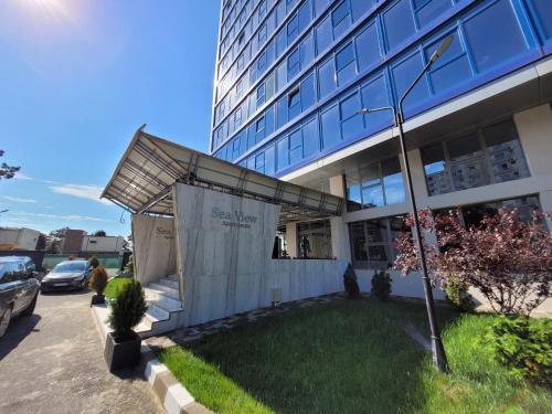 a building with a large building in front of it at Olimp Sea View 607 in Olimp